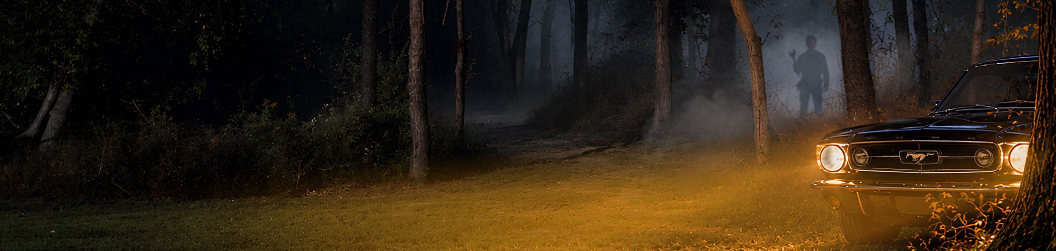 Mustang in misty woods with headlights on