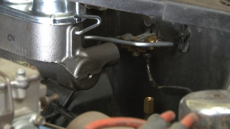 Mechanic attaching the union to the new rear brake line