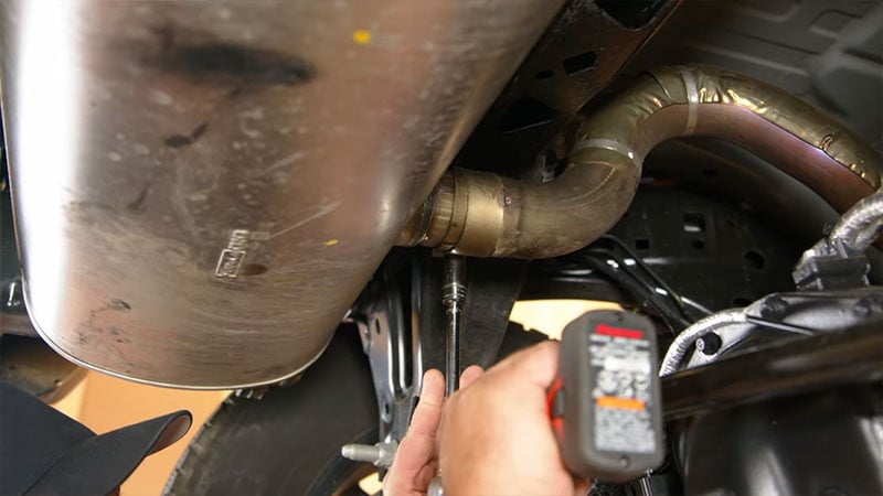 Loosening the muffler clamp on a 6th generation Bronco