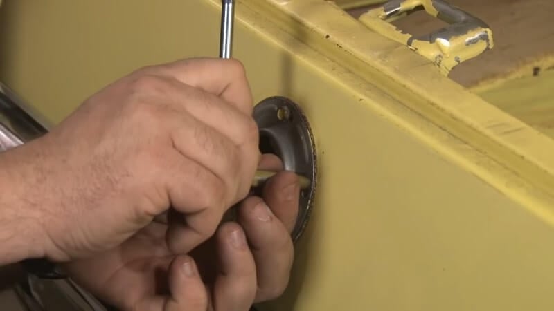 Mechanic tightening down the fuel filler pipe hardware