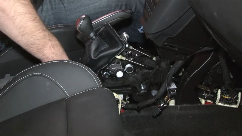Mechanic installing new shifter bolts on a Ford Focus ST