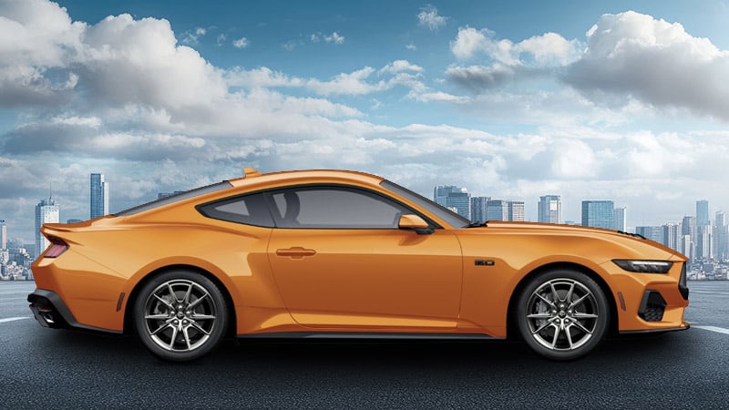 A side-angle render of a 2027 Mustang GT in Orange Fury Metallic Tri-coat