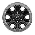 A black wheel with a silver beadlock ring on the outside