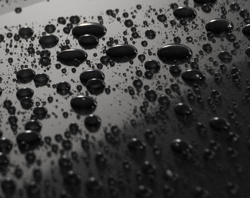 Ceramic-coated car panel with water beading on top