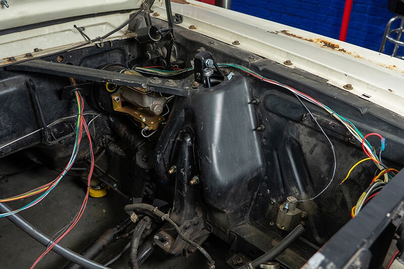A close up of the shock tower welds on a restored classic Mustang