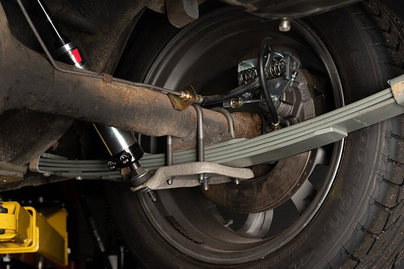 A wide angle shot of the leaf spring U-bolt attached to a classic Mustang