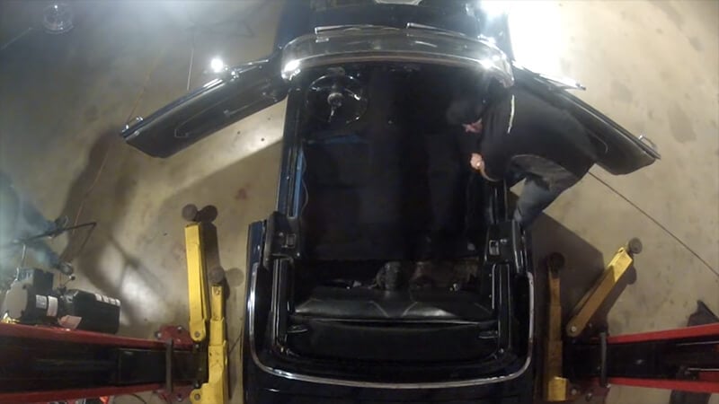 New carpet is placed and smoothed out in classic Mustang