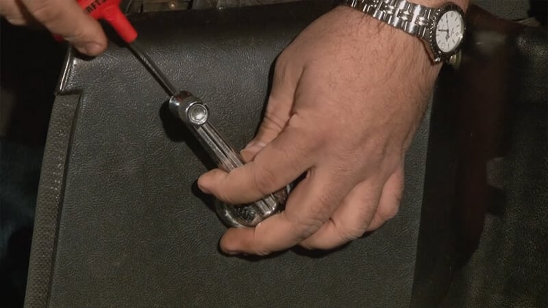 Unscrewing the bolt under the window crank handle