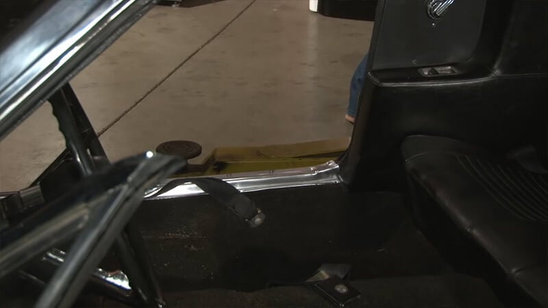 Front seats of classic Mustang have been removed, rear seats are about to be
