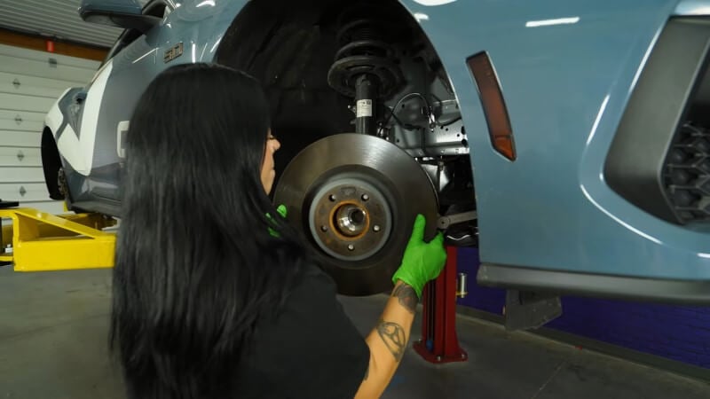 A mechanic sliding the brake rotor off of the hub assembly