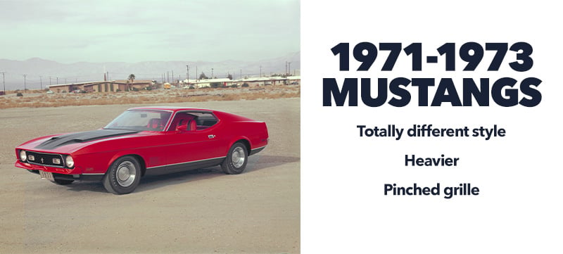 A red and black classic Mustang Mach 1 parked in the middle of a dusty lot