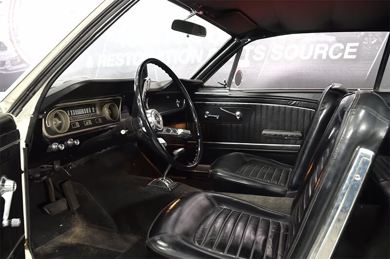 A close up picture of the interior of a classic Mustang in a shop