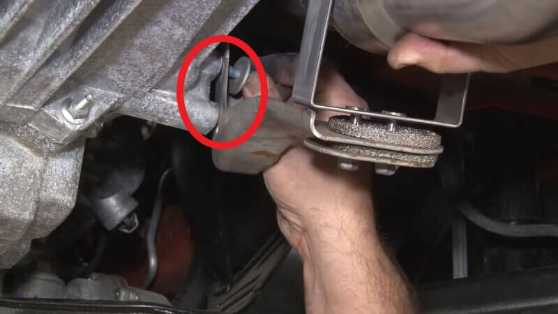 Mechanic seating the front pipe on a Mustang EcoBoost