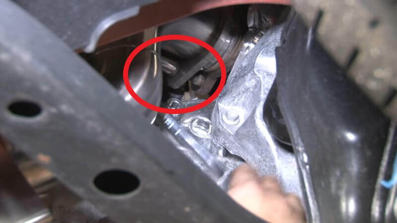 Mechanic reconnecting the front pipe to the turbo on a Mustang EcoBoost
