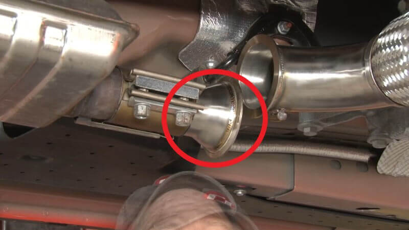 Mechanic connecting the secondary pipe to the resonator on a Mustang EcoBoost