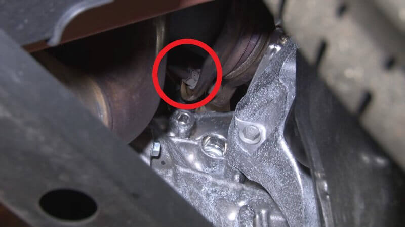Mechanic removing nuts attaching turbo to downpipe on a Mustang EcoBoost