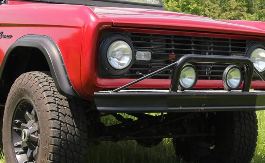 The front end of a red classic Bronco