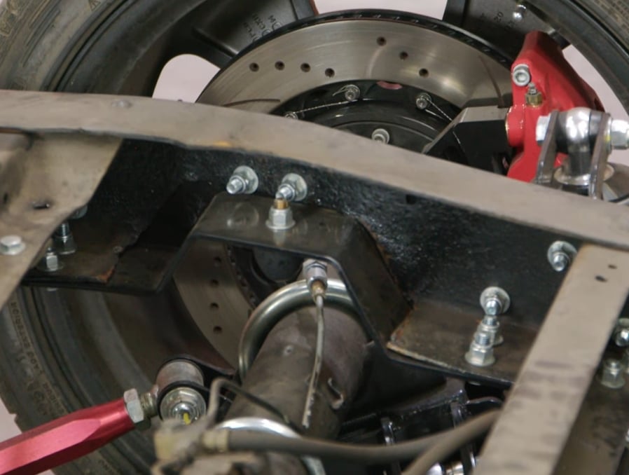 A close up shot of a C-notch kit installed on a Chevy C10