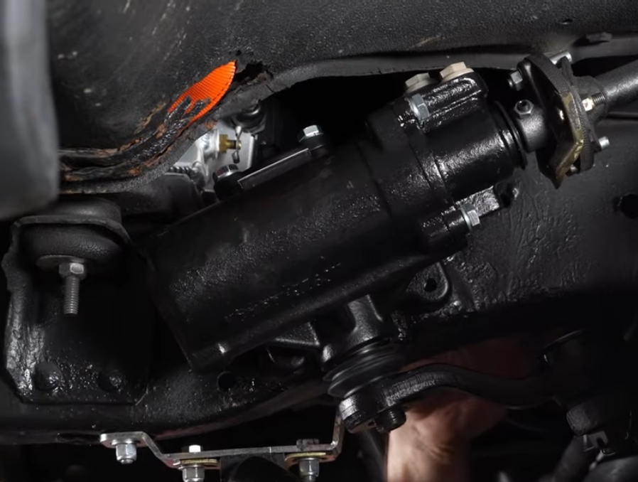 A close up of the power steering pump on a Chevy C10