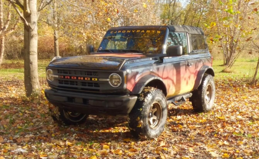 Ford Bronco parked in a field during fall